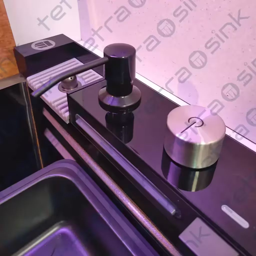 Close-up of a modern kitchen waterfall faucet with visible branding of tetrasink on a tiled wall.